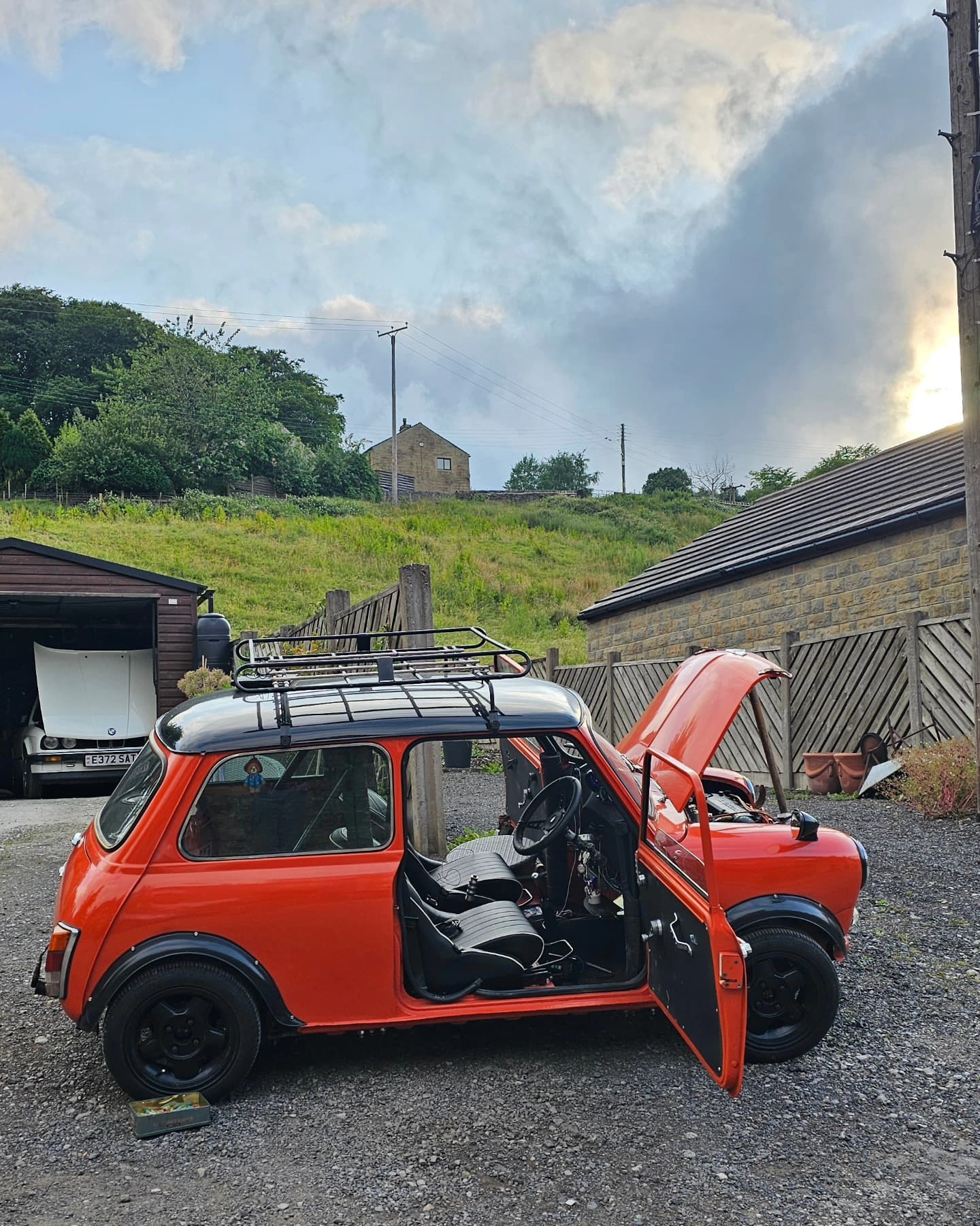 Classic Mini with Honda D14 engine swap and roof rack, doors open showing the swapped engine bay